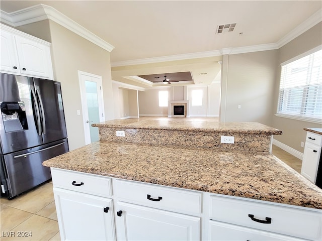 kitchen featuring ceiling fan, stainless steel fridge with ice dispenser, white cabinetry, and crown molding