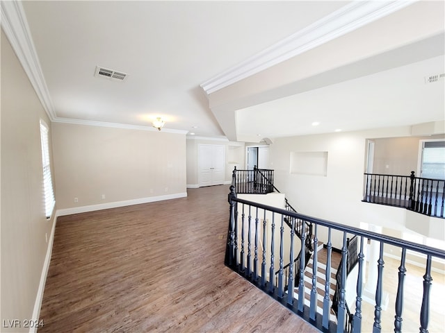 corridor with hardwood / wood-style flooring and ornamental molding