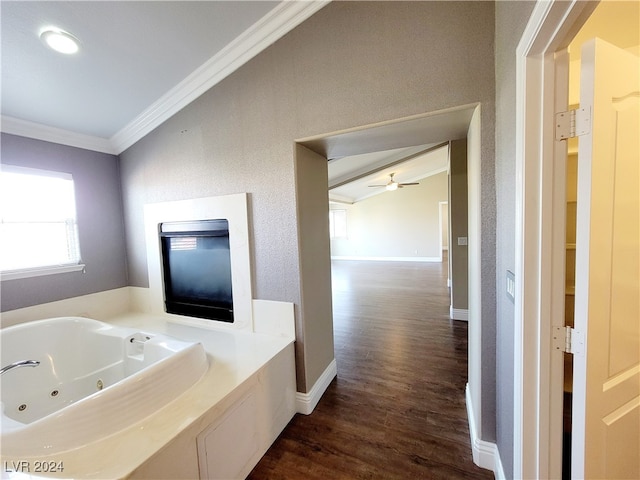 bathroom featuring ornamental molding, a washtub, wood-type flooring, and ceiling fan