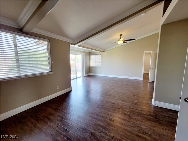 empty room featuring dark wood-type flooring, ceiling fan, ornamental molding, and vaulted ceiling with beams