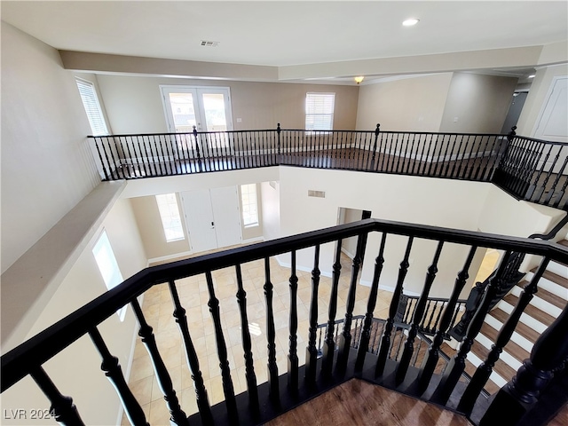 stairway featuring french doors and wood-type flooring