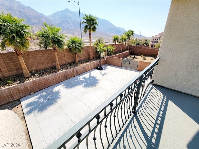 view of patio featuring a balcony and a mountain view