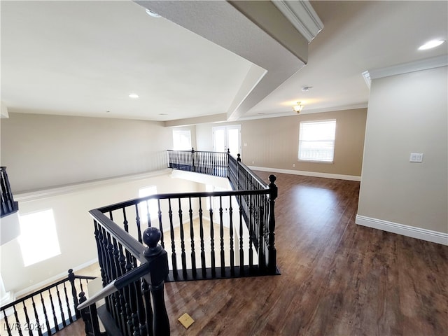 staircase featuring hardwood / wood-style flooring and ornamental molding