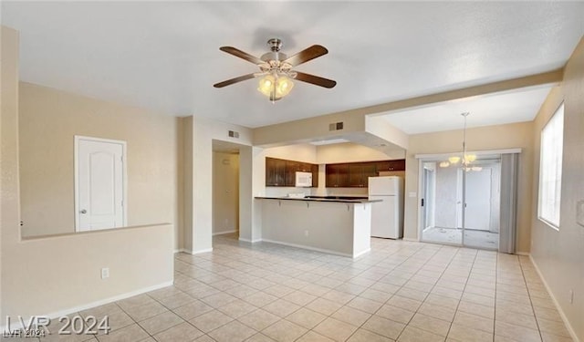 interior space with ceiling fan with notable chandelier and light tile patterned floors