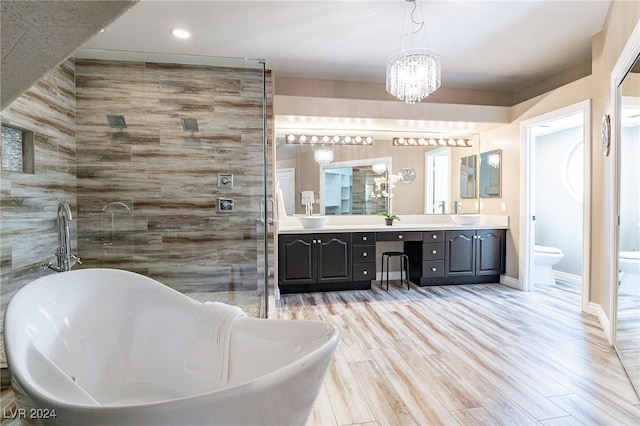 full bathroom with hardwood / wood-style flooring, vanity, tile walls, and toilet