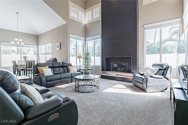 living room with carpet flooring, a healthy amount of sunlight, a fireplace, and a high ceiling