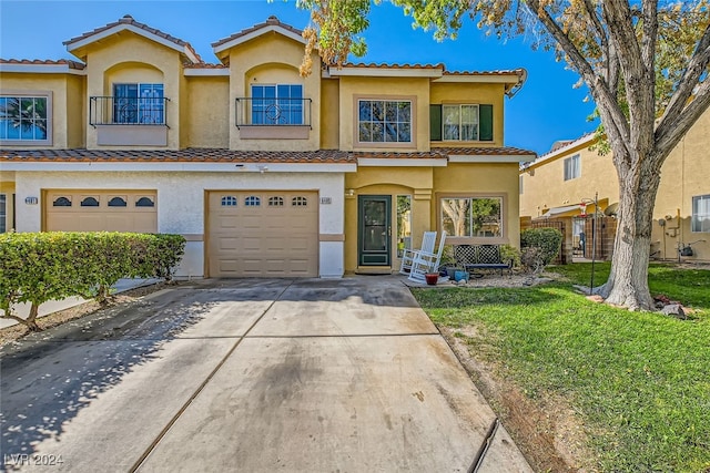 view of front of home with a garage and a front lawn