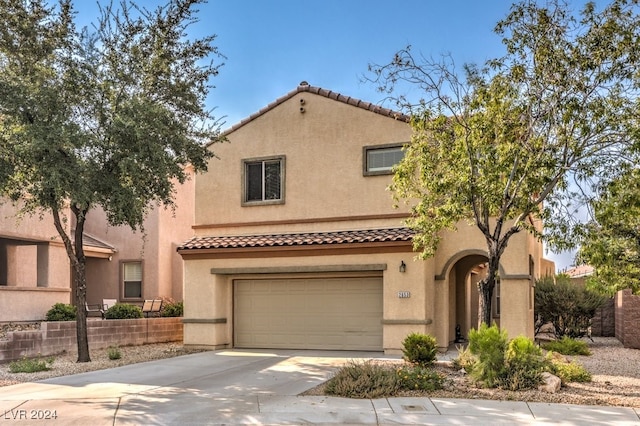 mediterranean / spanish house featuring a garage