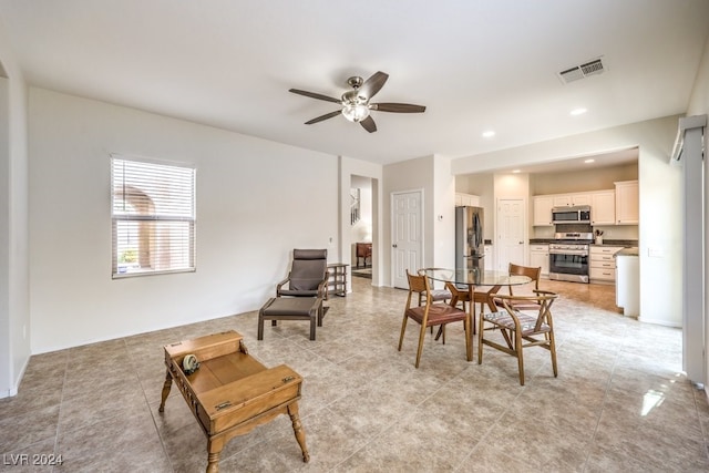 tiled dining area featuring ceiling fan