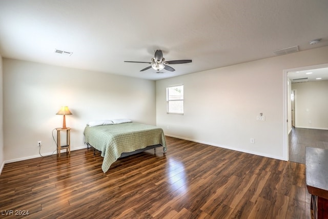 bedroom with ceiling fan and dark hardwood / wood-style flooring