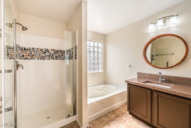 bathroom with vanity, independent shower and bath, and tile patterned flooring