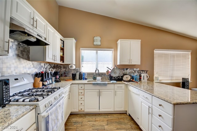 kitchen featuring white cabinets, lofted ceiling, kitchen peninsula, and white appliances