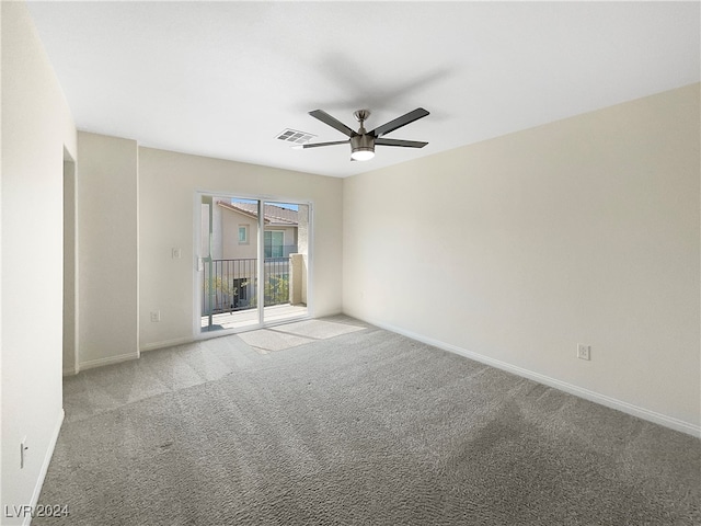 carpeted spare room featuring ceiling fan