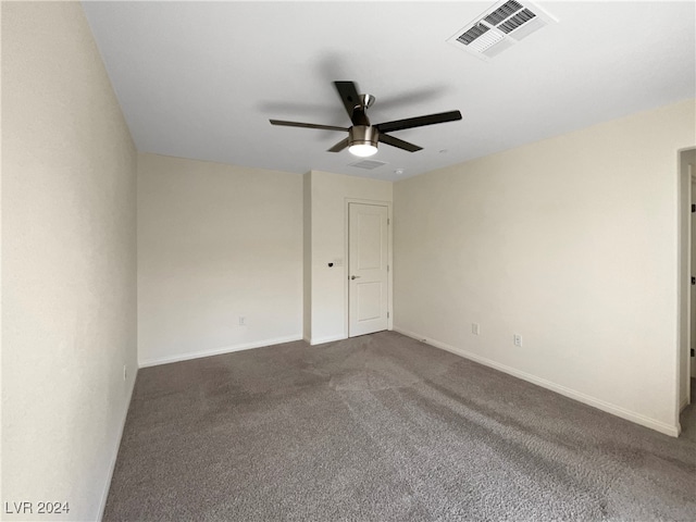 carpeted spare room featuring ceiling fan