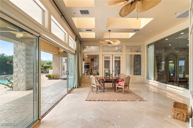 sunroom / solarium featuring ceiling fan and french doors