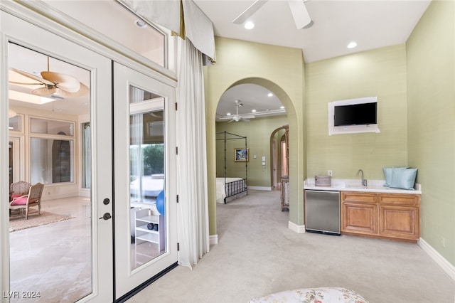 interior space featuring french doors, sink, and ceiling fan