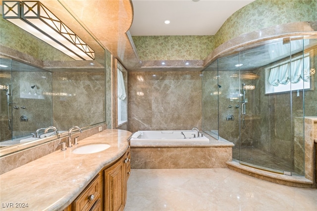 bathroom featuring vanity and separate shower and tub