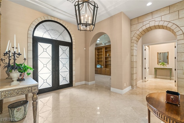 foyer entrance with a chandelier and french doors