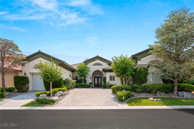 mediterranean / spanish-style home with a garage