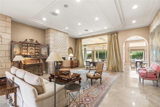 living room featuring a tray ceiling and plenty of natural light