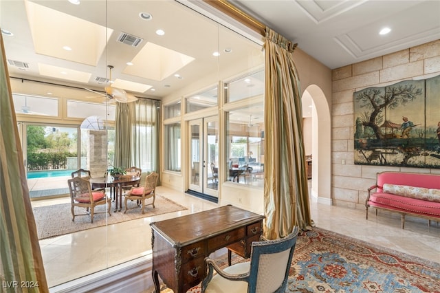 interior space featuring ceiling fan and a raised ceiling