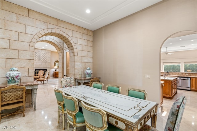 dining room with a tiled fireplace and sink