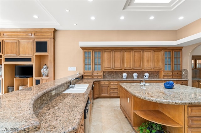 kitchen with light tile patterned floors, an island with sink, stainless steel dishwasher, sink, and light stone counters