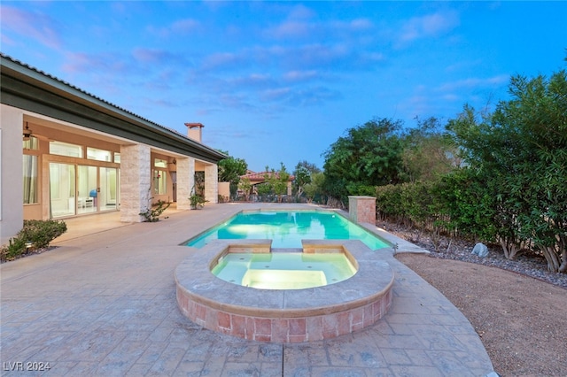 view of swimming pool with a patio area and an in ground hot tub