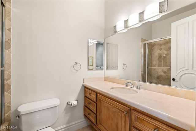 bathroom with vanity, toilet, and walk in shower