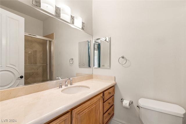 bathroom with vanity, toilet, and walk in shower