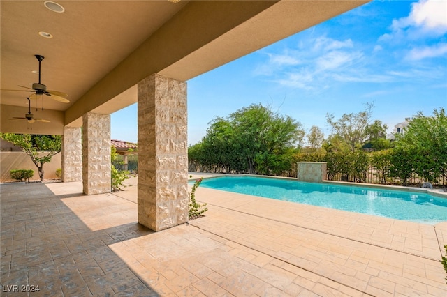 view of swimming pool with ceiling fan and a patio