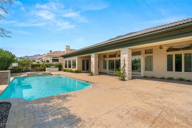 view of swimming pool featuring ceiling fan and a patio area