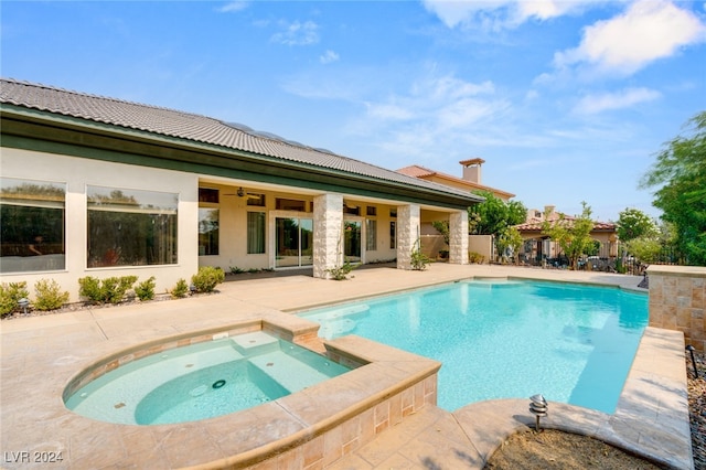 view of swimming pool with an in ground hot tub and a patio