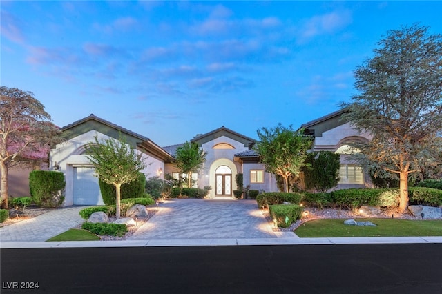 mediterranean / spanish house with a garage