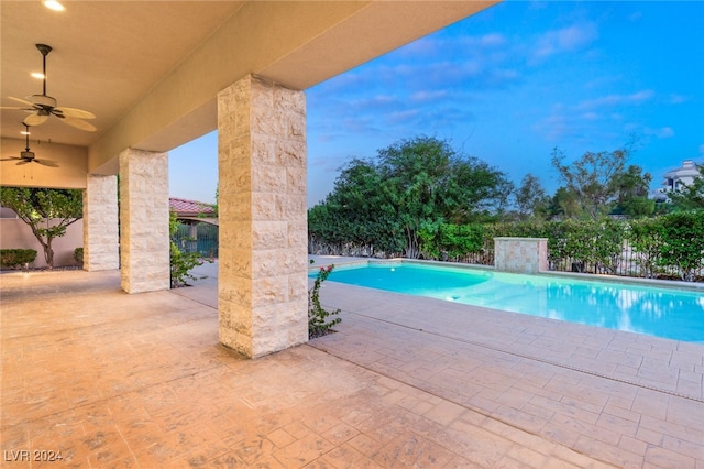 view of pool with a patio and ceiling fan