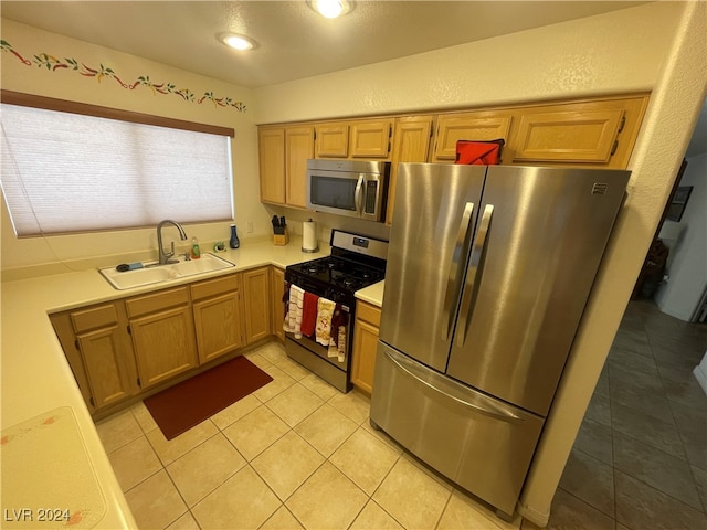 kitchen featuring sink, light tile patterned floors, and appliances with stainless steel finishes