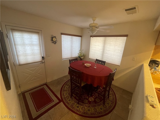 tiled dining area with ceiling fan