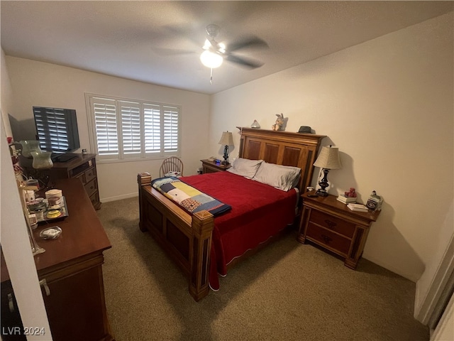 bedroom featuring dark colored carpet and ceiling fan