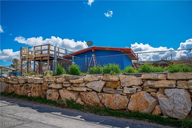 view of side of home with fence