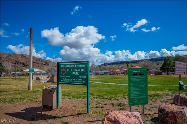 surrounding community featuring a mountain view and a yard