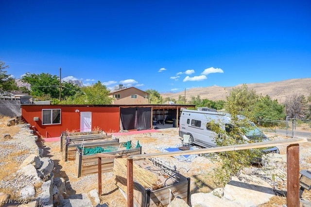 back of property featuring a garden and a mountain view