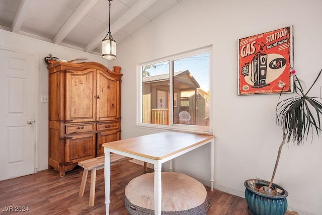 dining area with wood finished floors and vaulted ceiling with beams