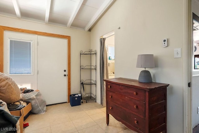 entryway featuring vaulted ceiling with beams and light tile patterned floors