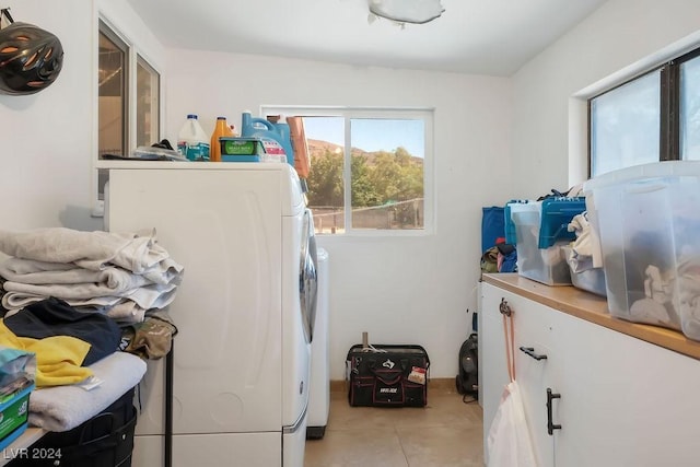 laundry area with washer / clothes dryer, light tile patterned flooring, and laundry area