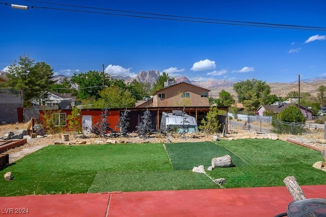 view of yard featuring a mountain view and fence