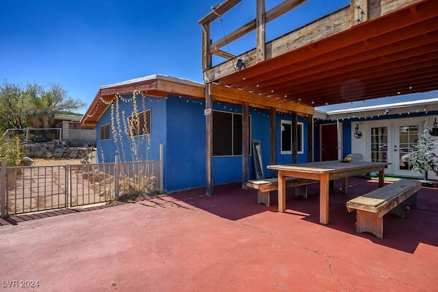 view of patio / terrace with fence, outdoor dining area, and french doors