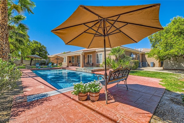 view of swimming pool featuring a patio and an in ground hot tub