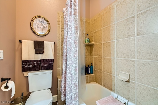 bathroom with shower / bath combo with shower curtain and toilet