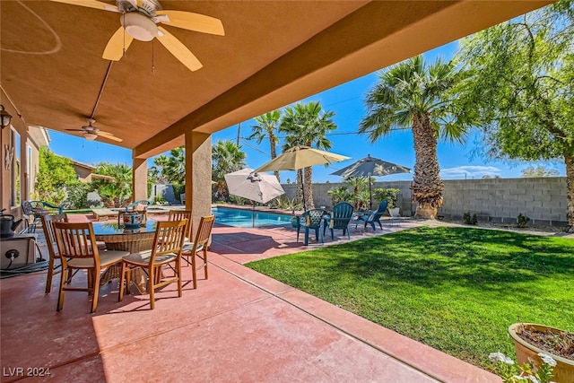 view of patio with ceiling fan and a fenced in pool