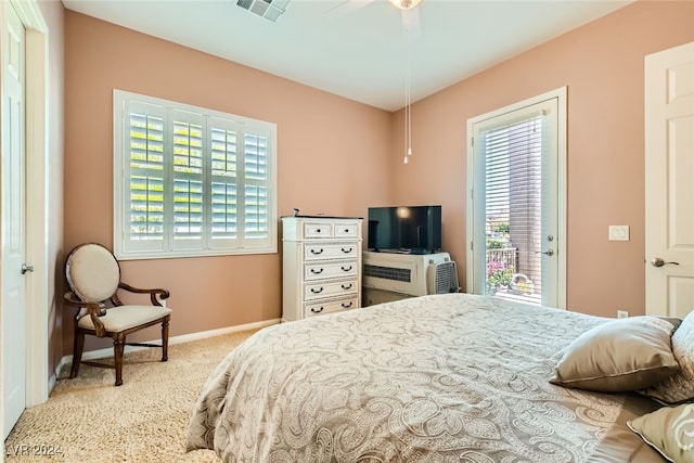 bedroom featuring access to exterior, light colored carpet, and ceiling fan